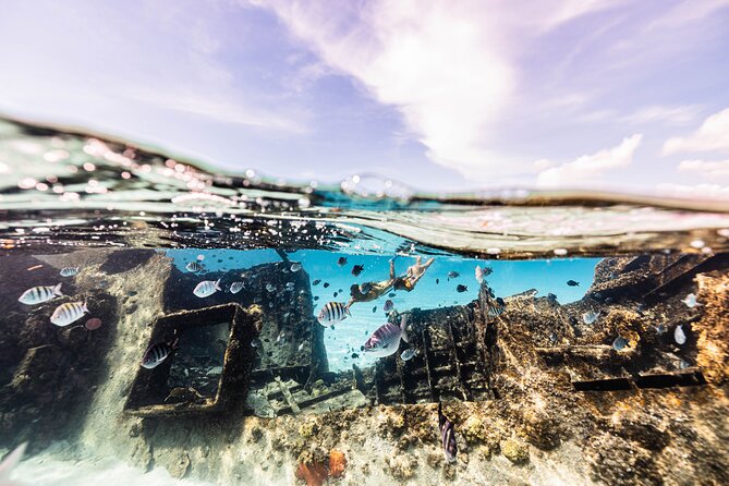 5-in-1 Cancun Snorkeling Tour with Sea Life & Transport Included - A shipwreck in a turquoise pool
