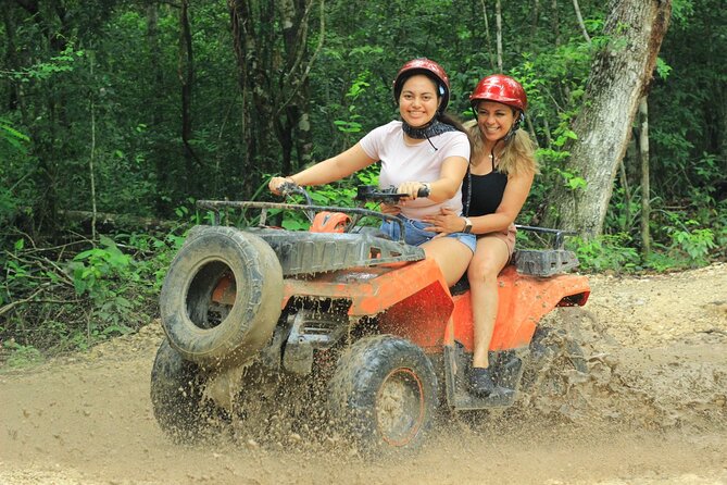 Cancun Jungle Adventure ATVs, Ziplines & Cenote Swim - ATV tracks through dirt, puddles, and thick greenery