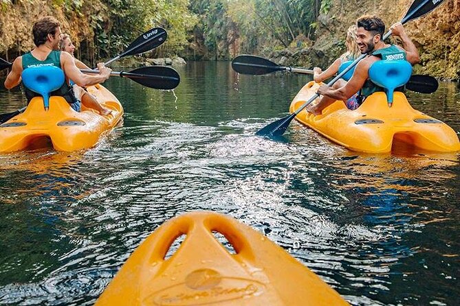 Discover and Descend on the Hidden Xenotes Tour From Cancun - K’áak’ Cenote: kayaking under fiery reflections