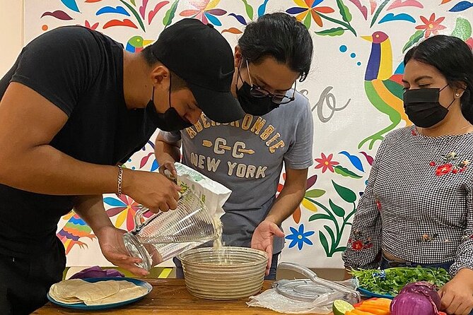 Elaboration of tortillas by hand following the Mexican tradition - Building tacos with beans, cheese, and local-style toppings